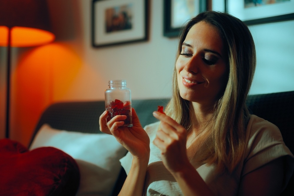 young-woman-with-gummies-in-bott